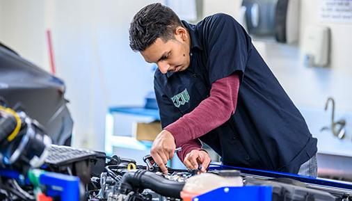 Student working on electric vehicle