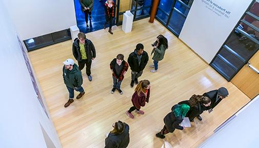 Students looking at artwork in the Teaching Gallery