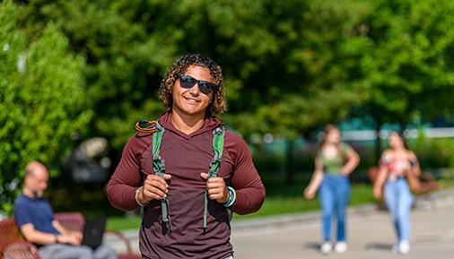 Male student with backpack on campus