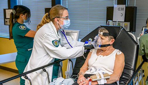 Nursing students work on a patient on a stretcher